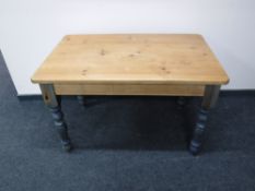 A rectangular pine kitchen table
