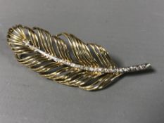 An 18ct gold diamond set leaf brooch, 7.6g.
