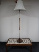 A nest of three teak tables, together with a teak tile top coffee table,