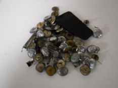 A box containing fire service buttons and badges