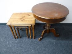A circular mahogany pedestal drum table and nest of three pine tables