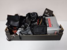 A box of assorted cameras and accessories including Practika, Pentax, Sony,