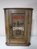 A small antique hanging oak corner cupboard bearing Wills Cigarette advertisement