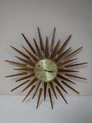 A Seth Thomas teak sunburst clock CONDITION REPORT: Fingertip sized dent to the dial