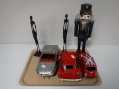 A tray containing two metal tribal figures,