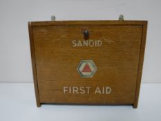 A mid 20th century oak Sanoid first aid box