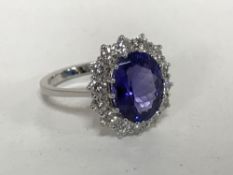 An 18ct white gold tanzanite diamond cluster ring, size N/O.