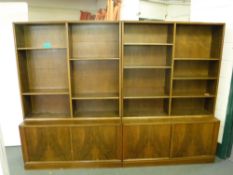 A mid 20th century walnut twin section bookcase fitted cupboards beneath