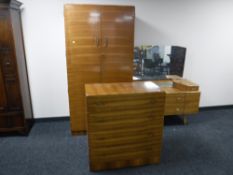 A mid twentieth century walnut three piece bedroom suite