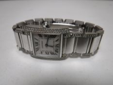 An 18ct white gold Cartier Lady's wrist watch, the shoulders, sides,