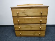 A pine four drawer chest