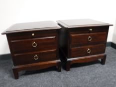A pair of Stag Minstrel bedside chests in a mahogany finish