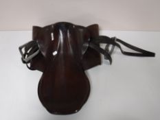 A leather saddle with stirrups