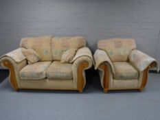 A pine framed two seater settee and armchair with a beech coffee table