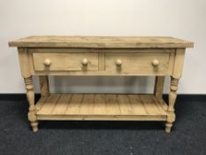 A reclaimed pine two drawer kitchen table with undershelf