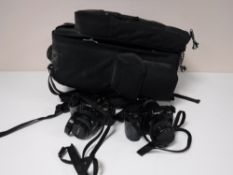 A case containing a Minolta Dynax 7000i camera x2,