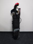 A Golden Bear golf bag containing assorted irons and drivers
