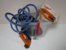 A box containing gas torch hoses and accessories