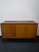 A mid 20th century teak sideboard fitted four drawers