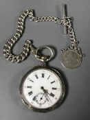 A silver pocket watch with silver Albert and medal.