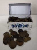 A tin containing Georgian pennies and half pennies, three pence pieces,