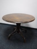A circular bentwood pedestal table