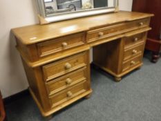 A pine twin pedestal dressing table,