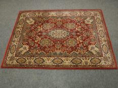 A Persian rug on red ground,
