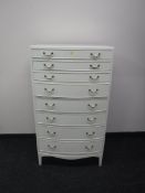 A mid 20th century bow fronted seven drawer chest