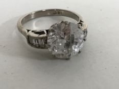 An 18ct white gold dress ring with diamond set shoulders,