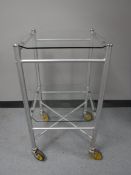 A mid 20th century metal two tier medial trolley with glass shelves