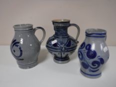 Three blue and white glazed German jugs