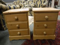 A pair of pine three drawer bedside chests,