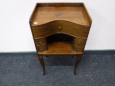 An early 20th century mahogany bedside stand fitted five drawers on tapered legs