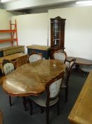 An eight piece Italianate dining room suite comprising of table and five chairs,