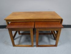 A mid twentieth century nest of three teak tables