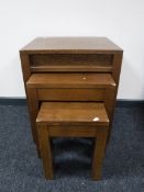 A nest of three contemporary oak tables