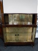 A mid twentieth century walnut display cabinet