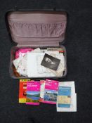 A vintage suitcase containing a quantity of vintage maps