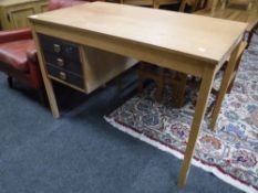 A late 20th century teak desk fitted three drawers