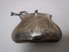 An engraved silver purse