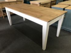 A pine farmhouse dining table with painted base