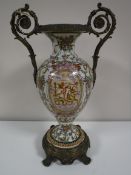 A continental china vase with gilt metal handles and on gilt metal base,
