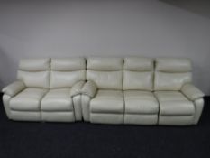 A cream leather reclining three seater settee and matching two seater settee