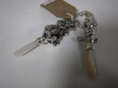 Two silver rattles; Mr.