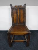An antique carved oak hall chair