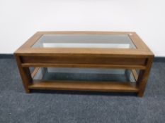 A contemporary oak glass topped side table,