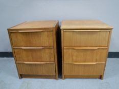 A pair of mid twentieth century teak three drawer bedside chests