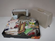 A cased New home sewing machine, with instructions,