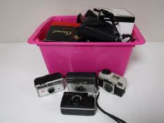 A box containing assorted vintage cameras